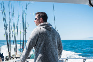 A man looking over the edge of a fishing boat