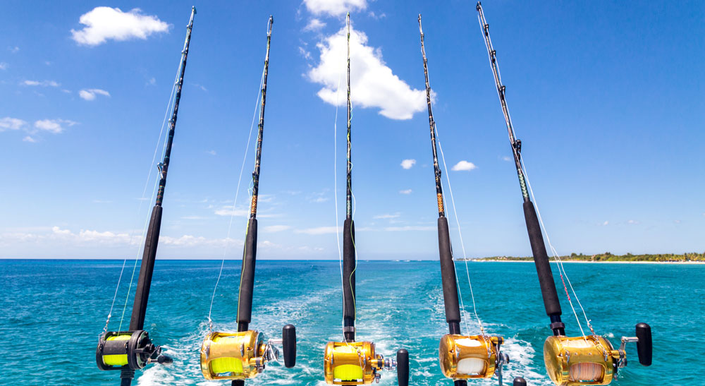 A line of rods in the water on a fishing boat